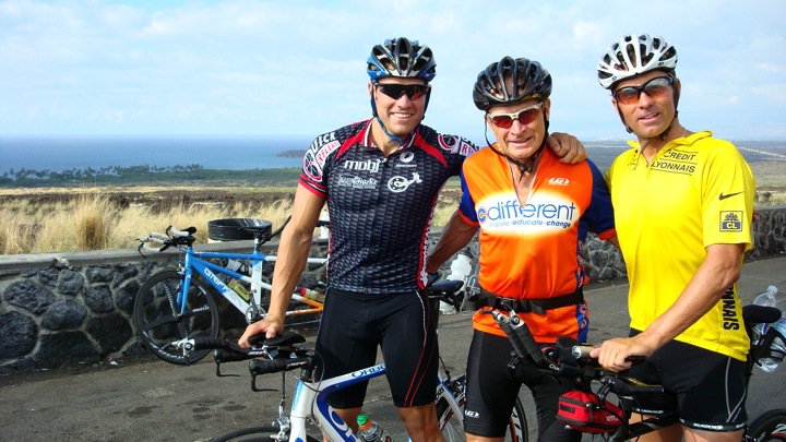 Cyclists in C Different gear standing with bikes near an overlook.