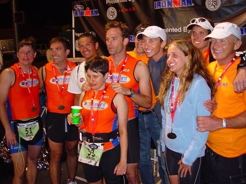 A guide and athlete running together on a road course.